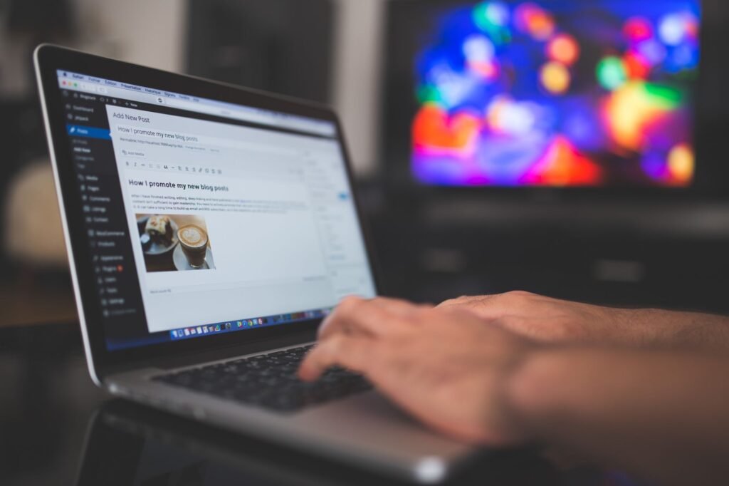 Writing a blog on a laptop at a desk